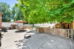Fenced backyard with a patio and outdoor dining area.