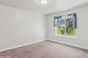 Spare room with carpet flooring and baseboards
