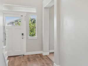 Foyer featuring baseboards and light wood finished floors