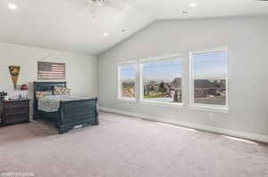 Carpeted bedroom with lofted ceiling, recessed lighting, and a ceiling fan