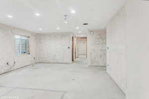 Empty room featuring recessed lighting and unfinished concrete floors