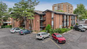 View of apartment building / complex with uncovered parking