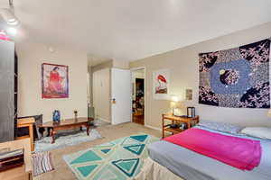 Carpeted bedroom featuring baseboards
