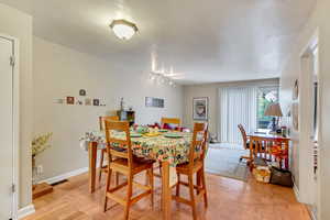 Dining space with baseboards and track lighting