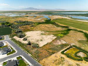 Aerial view of property and surrounding area with a water and mountain view