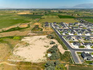 Aerial overview of property's location with a mountainous background and rural landscape
