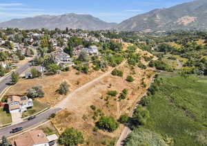 Aerial overview of property's location featuring a mountain backdrop and nearby suburban area