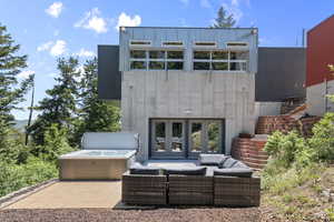 Back patio featuring a hot tub and outdoor lounge area