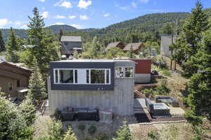 Rear view of home with mountain backdrop