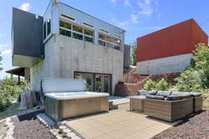 View of patio featuring a hot tub, outdoor lounge area, and french doors