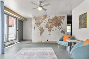 Sitting room featuring finished concrete floors, ceiling fan, and recessed lighting