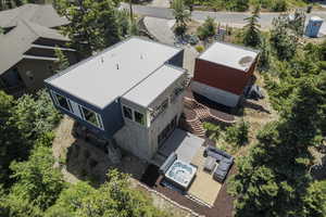 Aerial view of property and surrounding area featuring back patio and hot tub