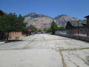View of asphalt parking lot featuring a mountain view, parking located on south side of building.