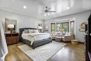 Primary bedroom featuring wood floors and a bay window