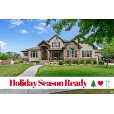 View of front facade featuring stone siding and stucco siding
