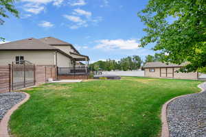 Fenced backyard featuring a deck