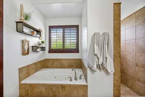Full primary bathroom with a whirlpool tub and a walk in shower