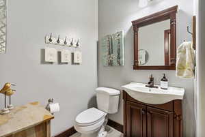 Half bathroom featuring vanity and toilet