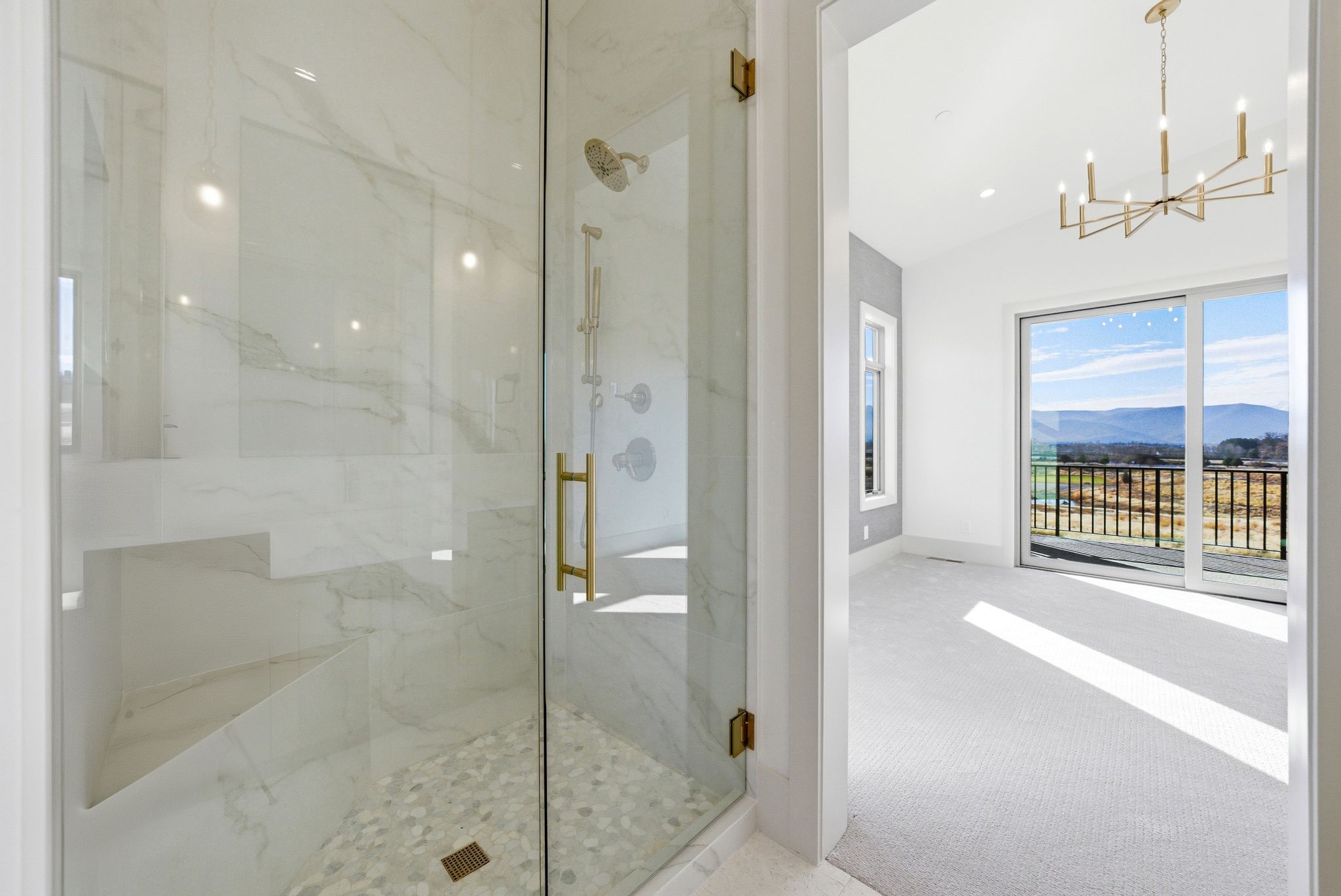 Full bath featuring a marble finish shower, a mountain view, carpet floors, lofted ceiling, and a chandelier
