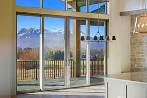 Doorway featuring a chandelier, a mountain view, and wood finished floors