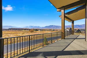 Balcony featuring a mountain view and a rural view