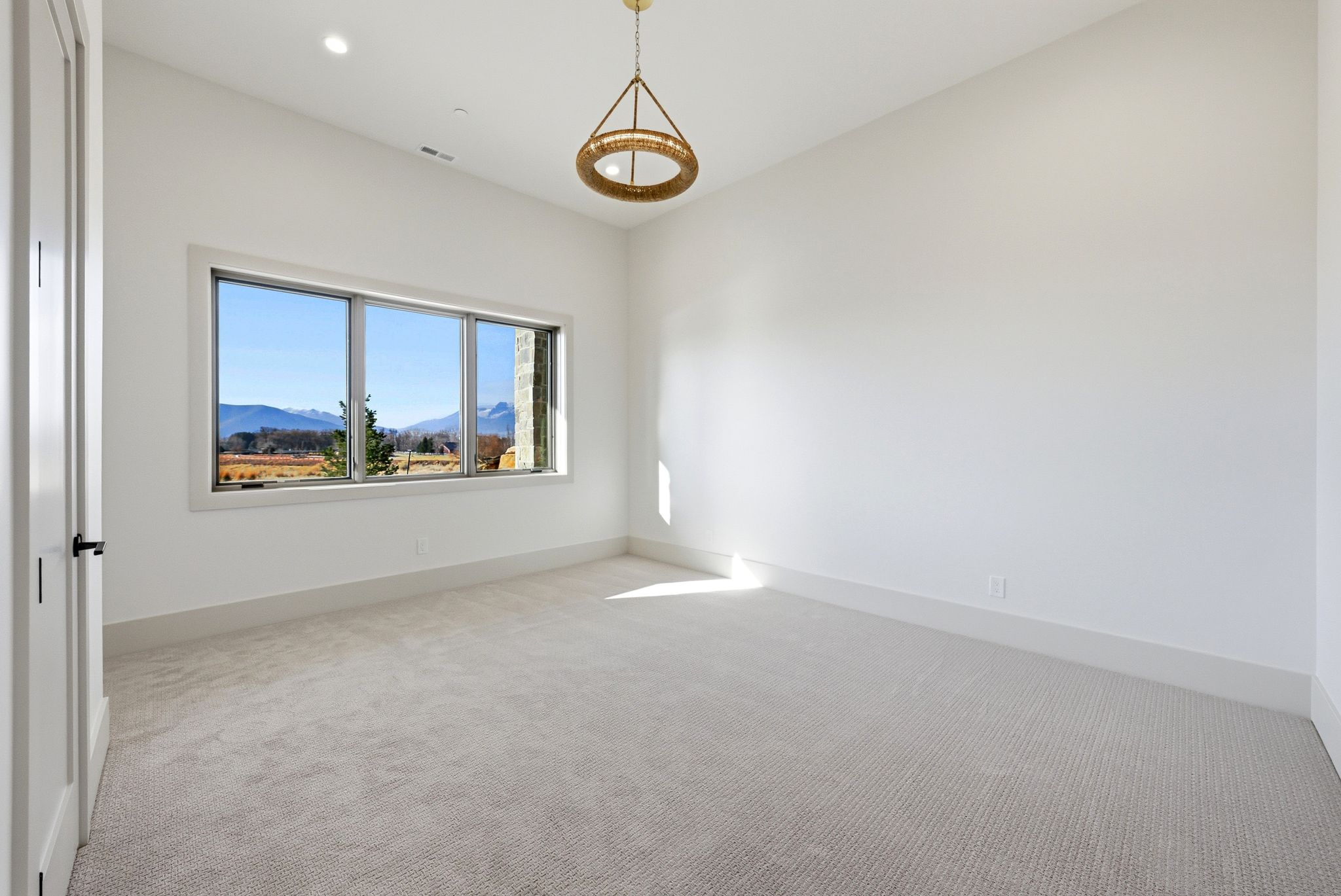 Carpeted spare room with a mountain view and recessed lighting