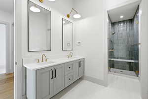 Bathroom with double vanity, a stall shower, and recessed lighting