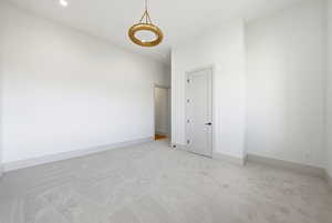 Unfurnished bedroom featuring carpet flooring and baseboards
