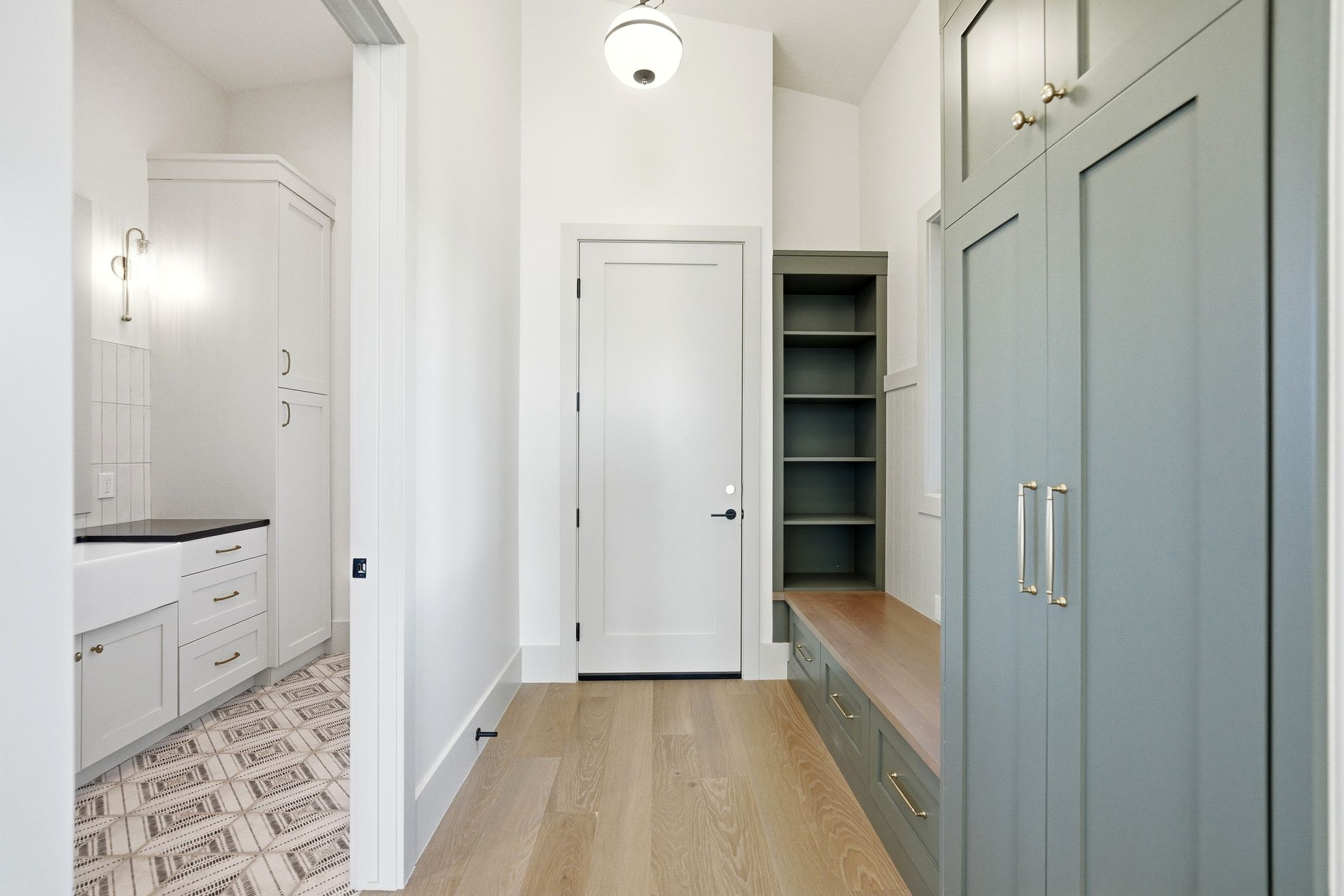 Mudroom with light wood-type flooring and baseboards