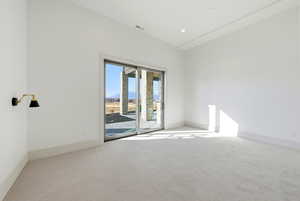 Empty room featuring carpet and baseboards