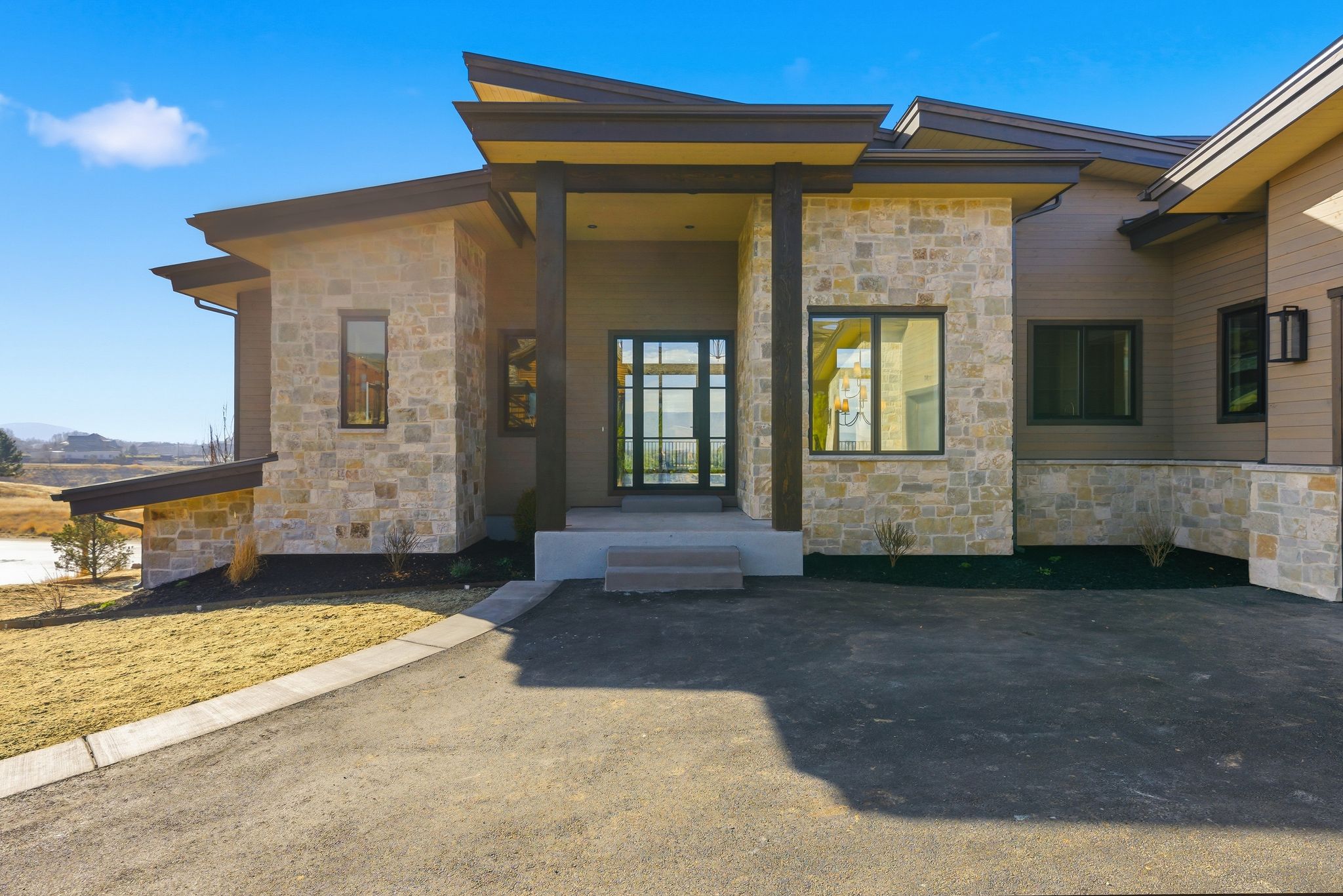 Entrance to property featuring stone siding