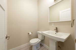 Bathroom with toilet and tile patterned flooring