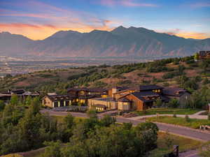 View of mountain backdrop featuring nearby suburban area