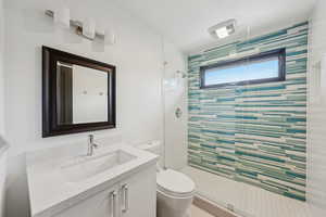 Full bathroom with a shower stall and vanity