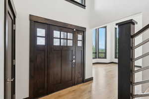 Foyer entrance with light wood-style floors and baseboards