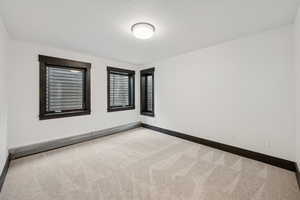 Unfurnished room featuring carpet floors and baseboards