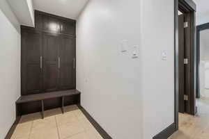 Mudroom featuring light tile patterned floors and baseboards