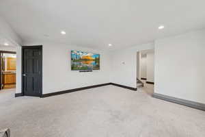 Unfurnished room with light carpet and recessed lighting