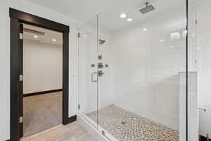 Bathroom with a shower stall and recessed lighting