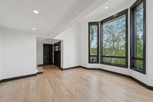 Spare room featuring light wood-style flooring and recessed lighting