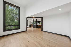 Empty room featuring plenty of natural light, light wood finished floors, and recessed lighting