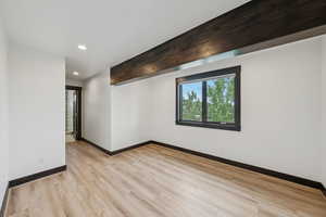 Spare room featuring light wood-type flooring and recessed lighting