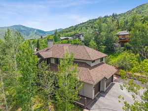 Aerial view of property and surrounding area with a mountain backdrop