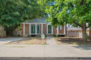 View of front facade featuring brick siding and a porch