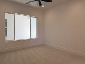 Empty room featuring light colored carpet, a ceiling fan, and recessed lighting