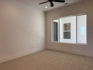 Empty room featuring light carpet, ceiling fan, and recessed lighting
