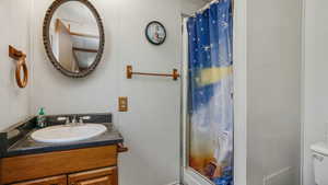 Primary en suite bath featuring vanity and a shower