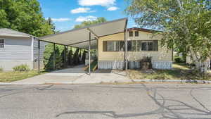 Manufactured home featuring a carport