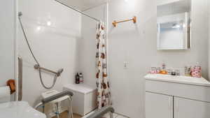 Full bathroom with vanity and a shower