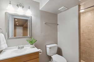 Bathroom with vanity and tiled shower
